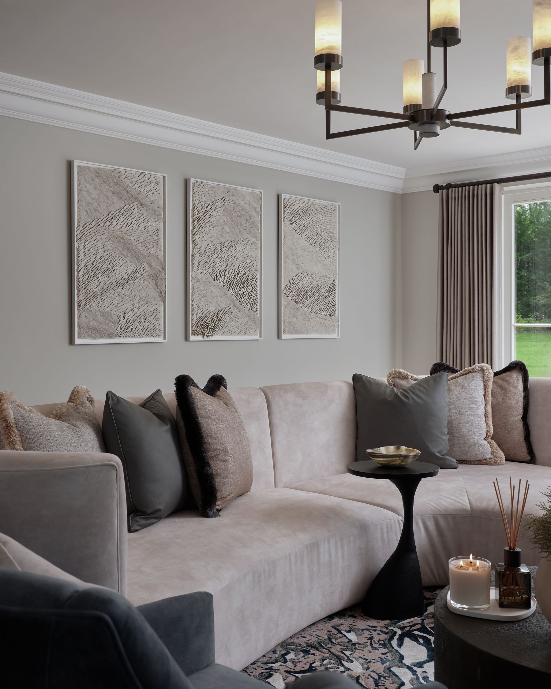 Layered sitting room with sculptural lighting and art